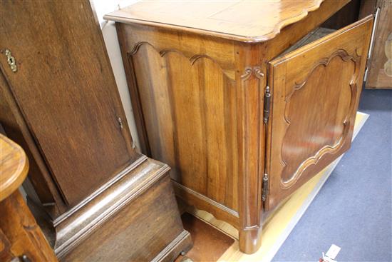 An 18th century French provincial walnut cabinet, with serpentine top and two panelled doors, W.138cm D.63cm H.95cm